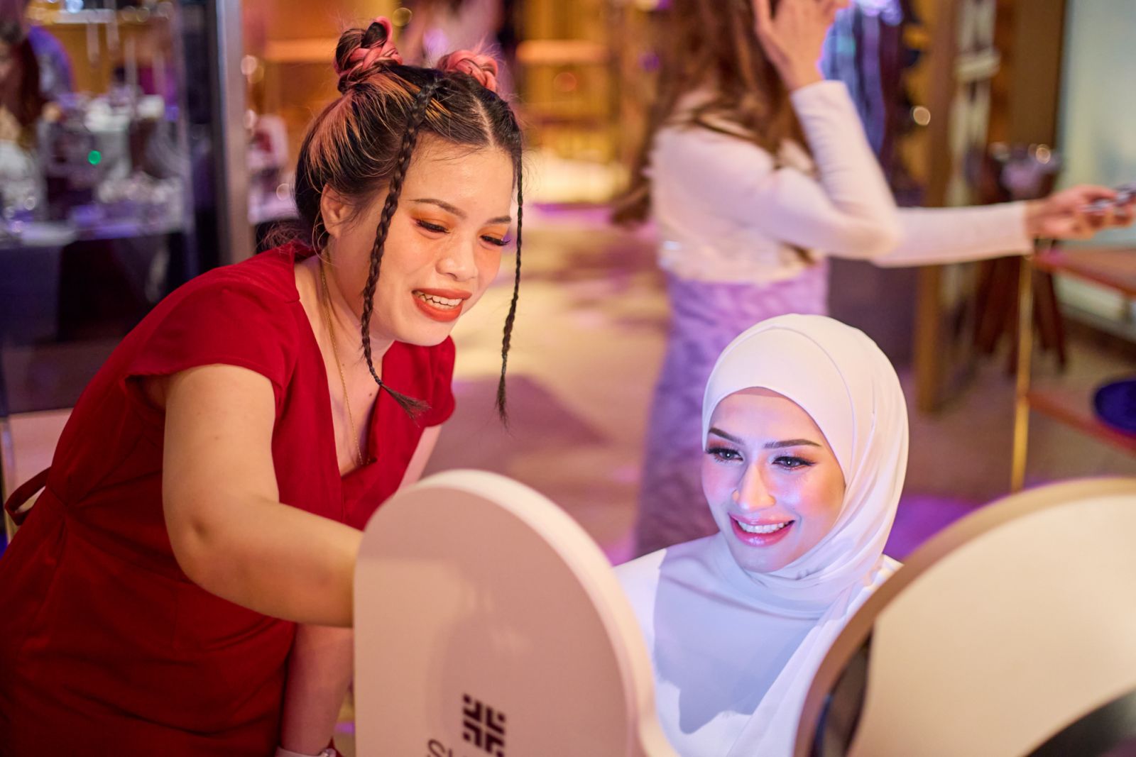A Sa Sa skin consultant assists Datin Niena Baharun