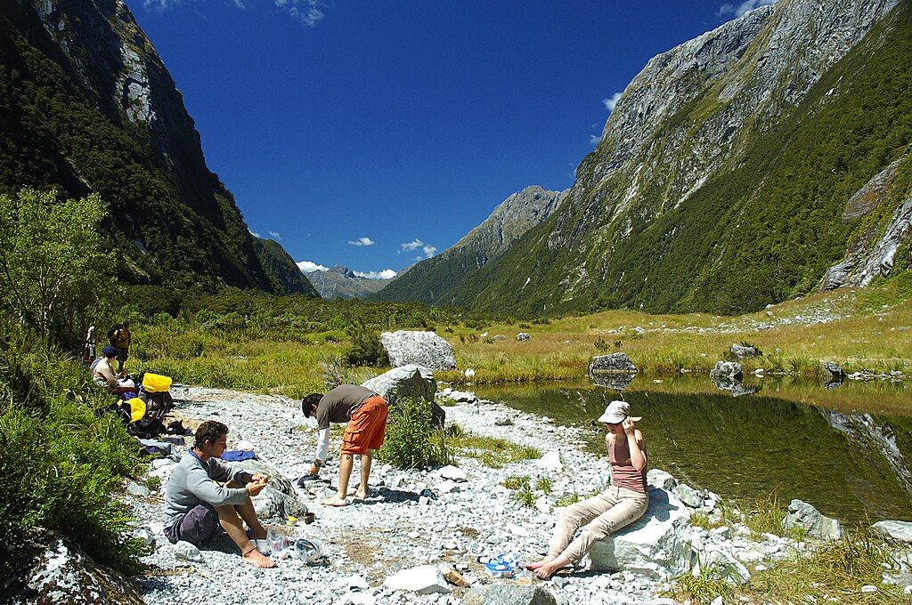 Trekkers resting at the Milford Track, New Zealand (Photo: Wikicommons)