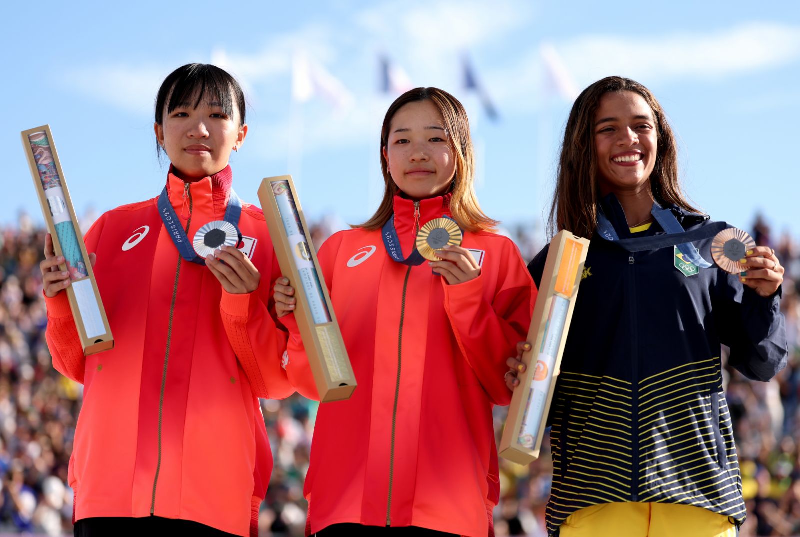 PARIS, FRANCE - JULY 28: Gold medalist Coco Yoshizawa of Team Japan (C), Silver medalist Liz Akama of Team Japan (L) and Bronze medalist Rayssa Leal of Team Brazil (R) pose on the podium during the Women's Street Final on day two of the Olympic Games Paris 2024 at Place de la Concorde on July 28, 2024 in Paris, France. (Photo by Julian Finney/Getty Images)