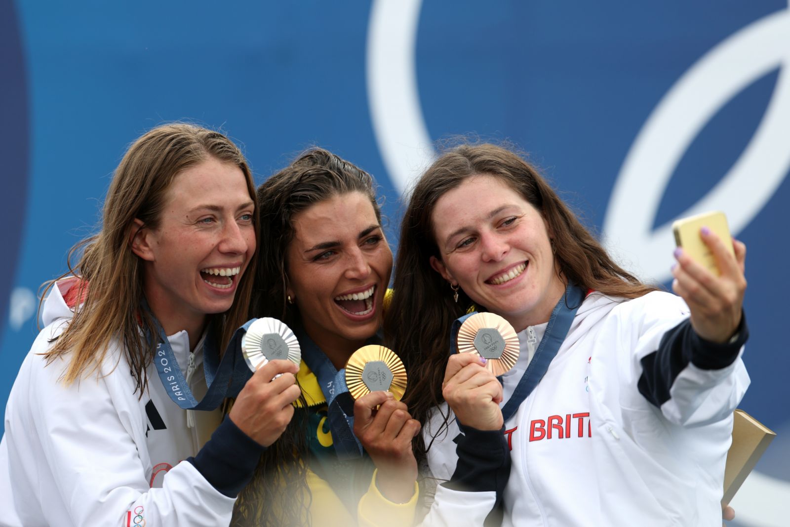 PARIS, FRANCE - JULY 28: Gold Medalist Jessica Fox of Team Australia (C), Silver Medalist Klaudia Zwolinska of Team Poland (L), and Bronze Medalist Kimberley Woods of Team Great Britain (R) pose for a selfie on the podium during the Canoe Slalom medal ceremony after the Women’s Kayak Single Final on day two of the Olympic Games Paris 2024 at Vaires-Sur-Marne Nautical Stadium on July 28, 2024 in Paris, France. (Photo by Francois Nel/Getty Images)