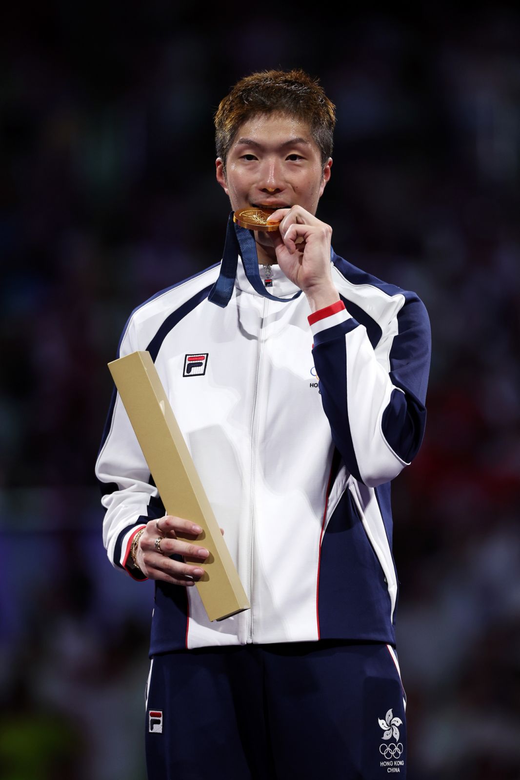 PARIS, FRANCE - JULY 29: Gold medalist Ka Long Cheung of team Hong Kong celebrates on the podium during the Men's Foil Individual medal ceremony on day three of the Olympic Games Paris 2024 at Grand Palais on July 29, 2024 in Paris, France. (Photo by Al Bello/Getty Images)