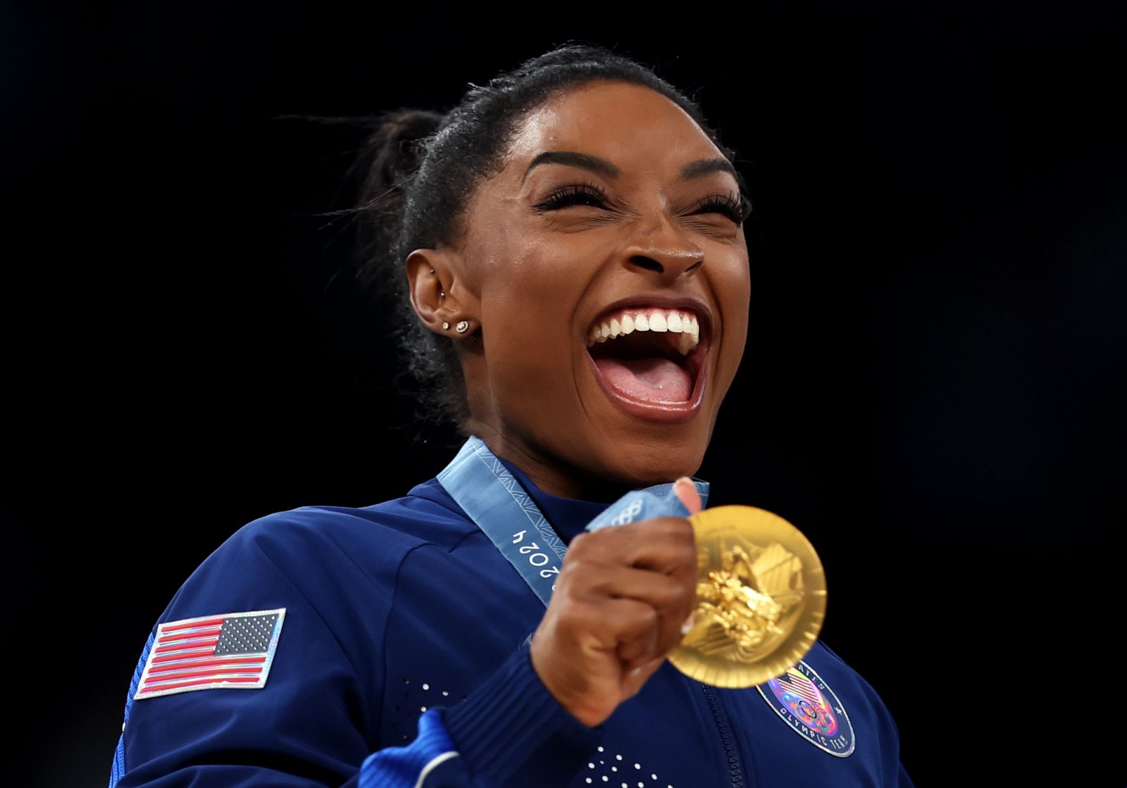 PARIS, FRANCE - JULY 30: Gold medalist Simone Biles of Team United States celebrates on the podium during the medal ceremony for the Artistic Gymnastics Women's Team Final on day four of the Olympic Games Paris 2024 at Bercy Arena on July 30, 2024 in Paris, France. (Photo by Naomi Baker/Getty Images)