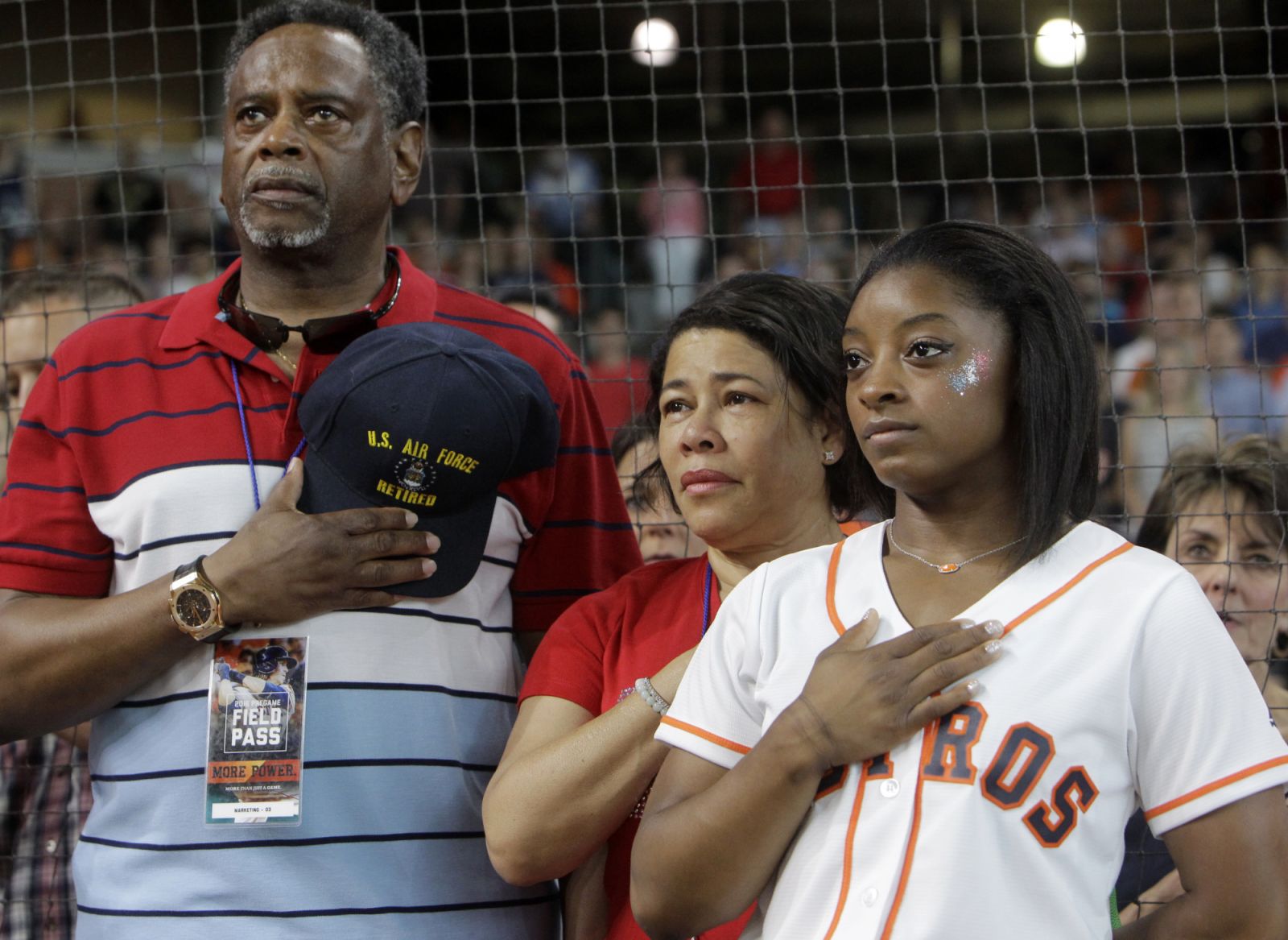 HOUSTON, TEXAS - JULY 4: Ron Biles and Nellie Biles with their daughter, Simone Biles, of Spring, who will participate in the upcoming Olympic Games in Rio, during the National Anthem before at the Houston Astros and Seattle Mariners game at Minute Maid Park Monday, July 4, 2016, in Houston. (Melissa Phillip/Houston Chronicle via Getty Images)