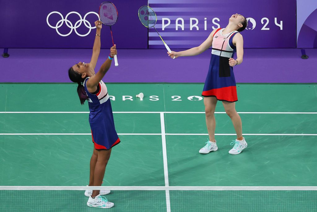 PARIS, FRANCE - JULY 30: Pearly Tan and Muralitharan Thinaah of Team Malaysia celebrate winning the Women's Doubles Group Play Stage - Group A match between Team Indonesia and Team Malaysia on day four of the Olympic Games Paris 2024 at Porte de La Chapelle Arena on July 30, 2024 in Paris, France. (Photo by Alex Pantling/Getty Images)