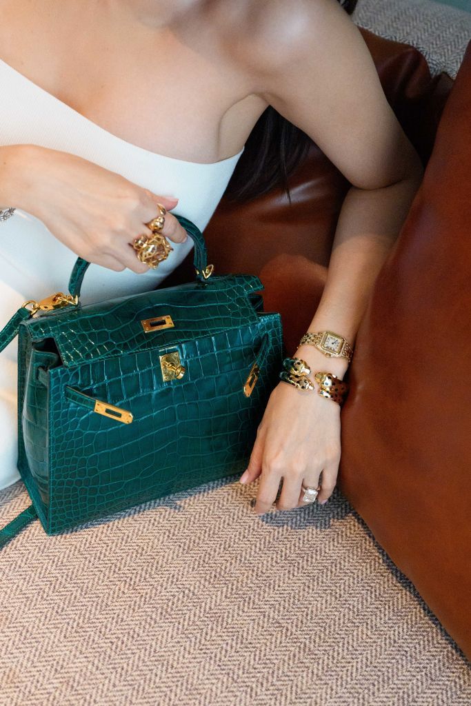 SINGAPORE, SINGAPORE - JULY 10: Heart Evangelista wears a green Hermes bag and golden Cartier jewelry, watch, bracelet and rings, on July 10, 2024 in Singapore. (Photo by Edward Berthelot/Getty Images)