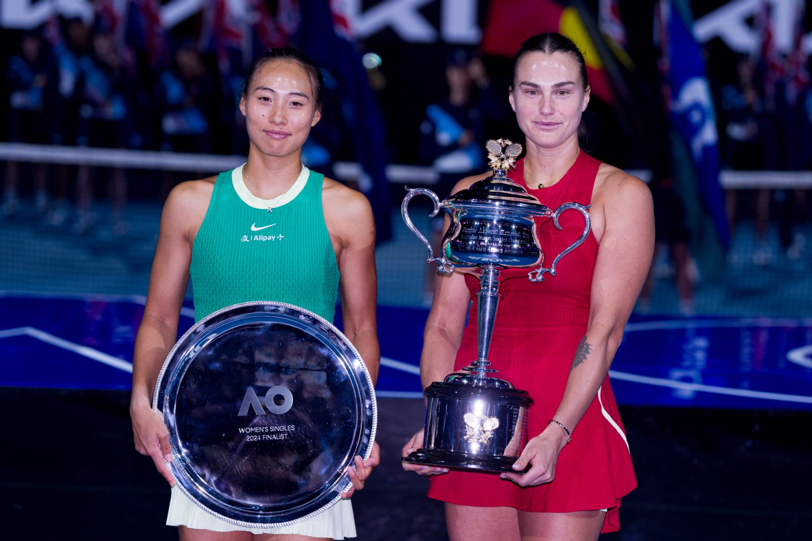 MELBOURNE, AUSTRALIA - JANUARY 27: Aryna Sabalenka (R) and Qinwen Zheng (L) of China pose with the trophies after their Women's Singles Final match during day fourteen of the 2024 Australian Open at Melbourne Park on January 27, 2024 in Melbourne, Australia. (Photo by Andy Cheung/Getty Images)