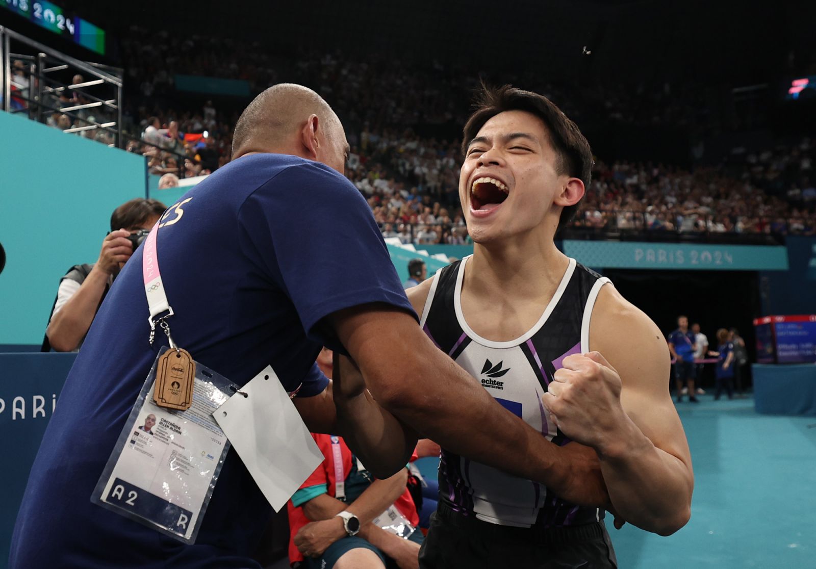 Carlos Edriel Yulo of Team Philippines reacts with his coach Aldrin Castaneda (L) after winning the Gold medal during the Artistic Gymnastics Men's Vault Final on day nine of the Olympic Games Paris 2024 at Bercy Arena on August 04, 2024 in Paris, France. (Photo by Jamie Squire/Getty Images)