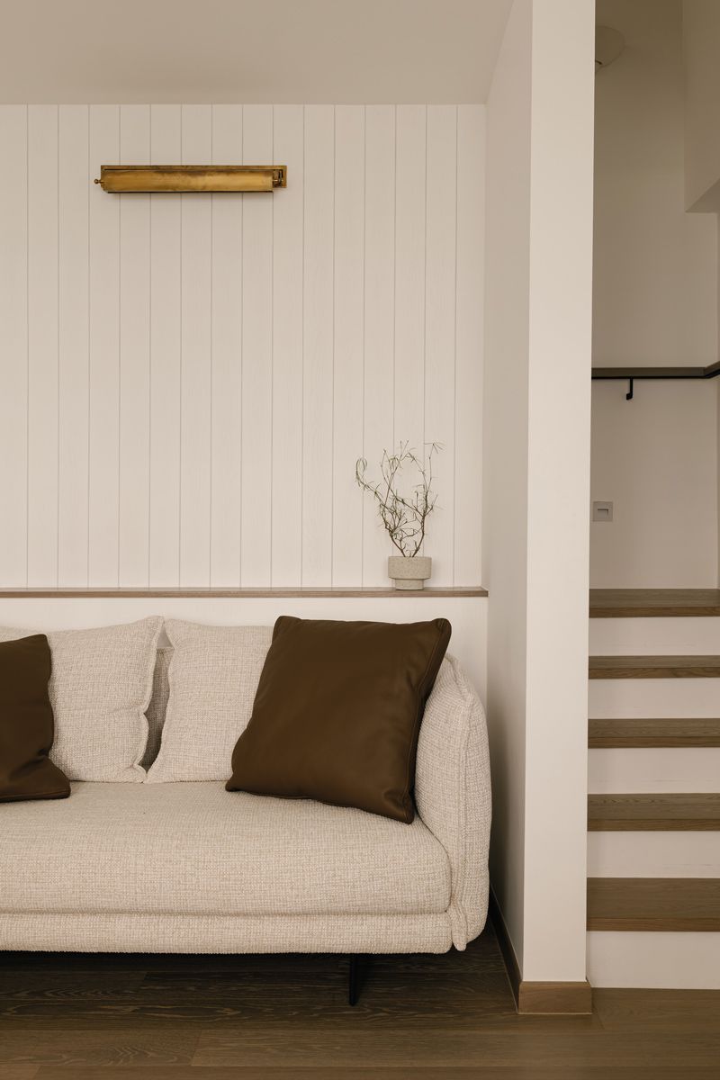 This well-appointed sitting nook brings cosiness to the staircase area