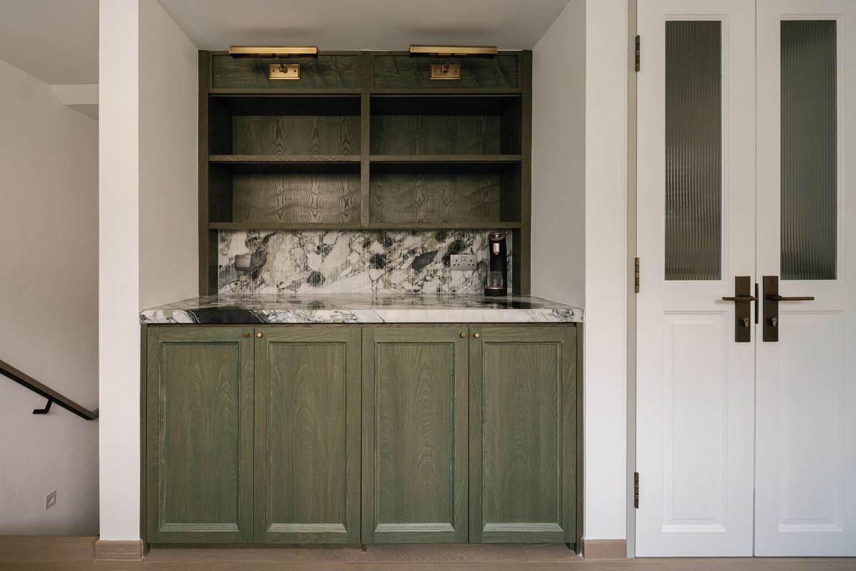 A green cabinet brings vigour to the neutral palette