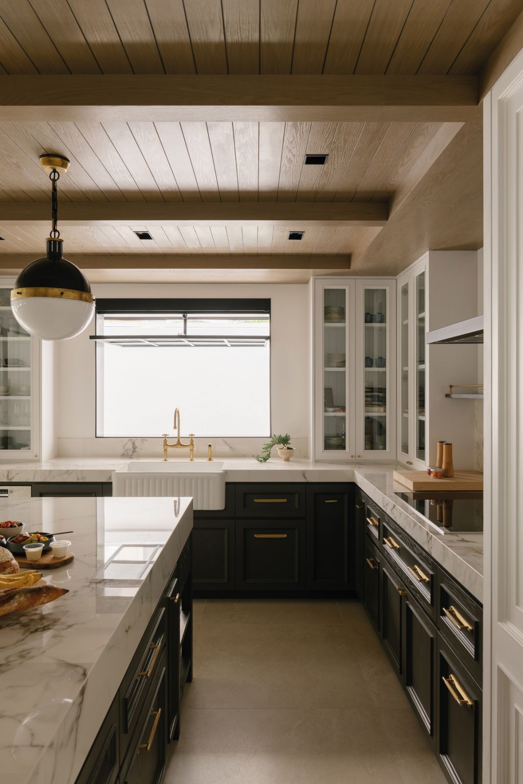 Glossy countertops lend a luxurious feel to the kitchen