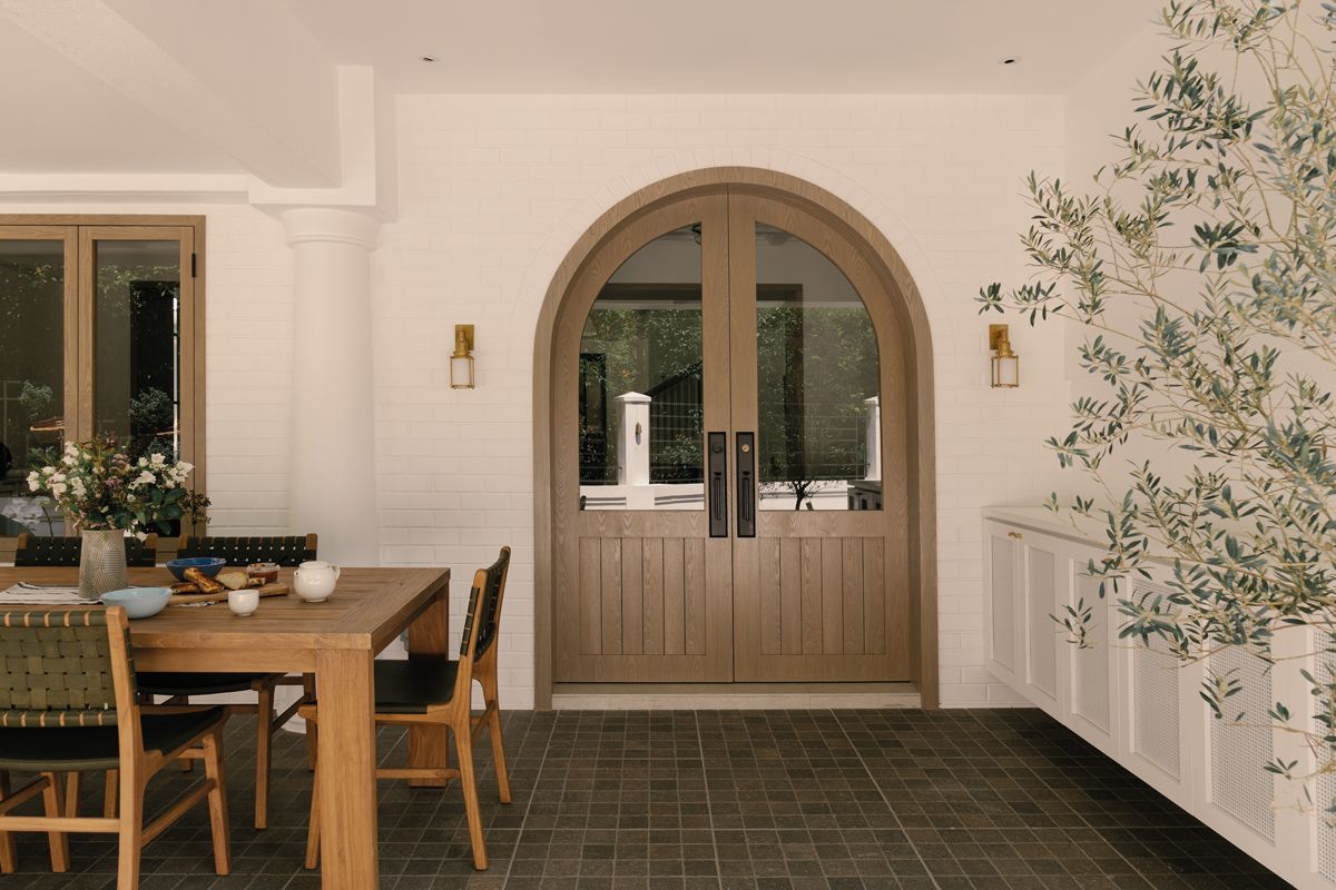 These arched double doors with glass-panel inserts channel a Mediterranean feel