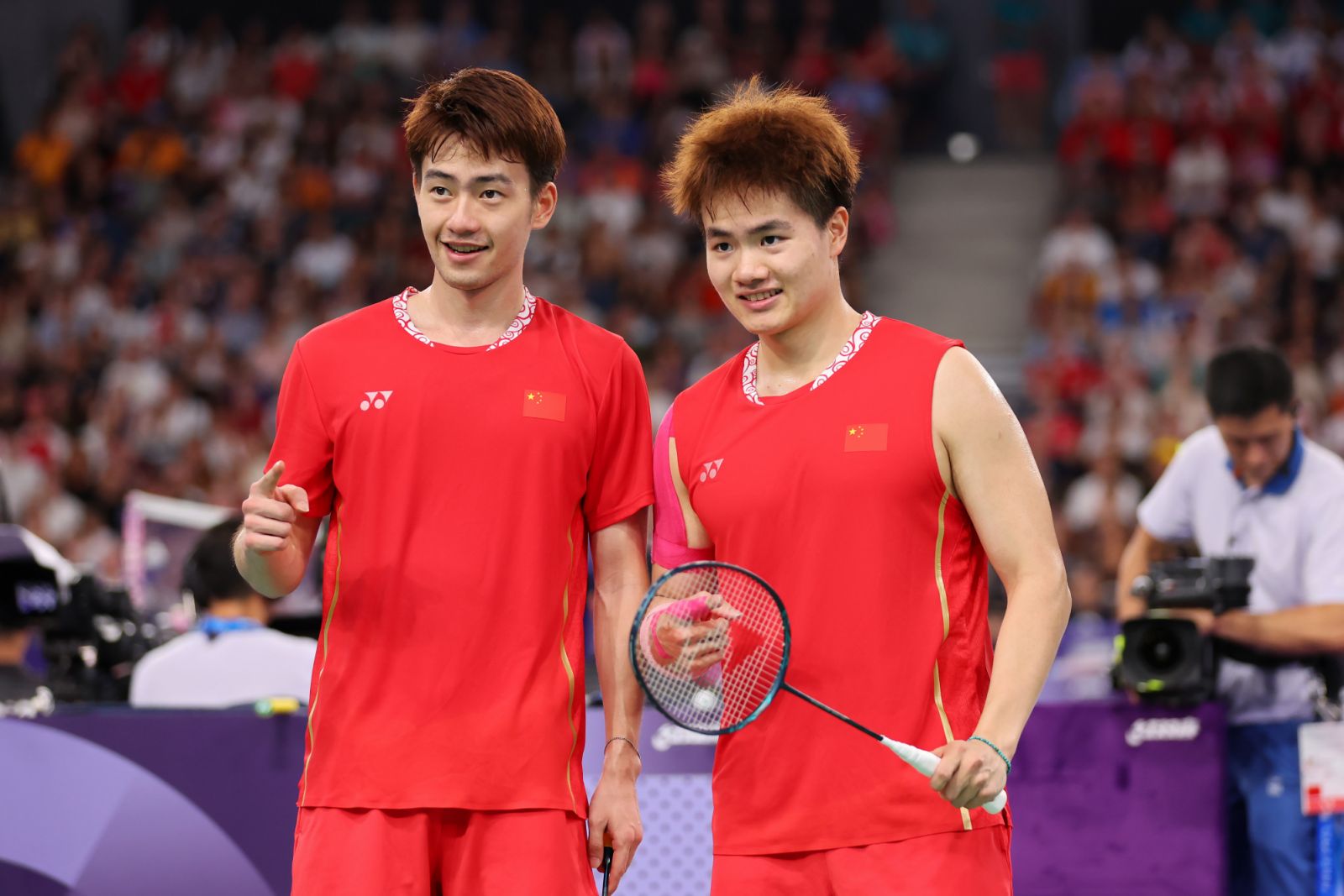 PARIS, FRANCE - AUGUST 01: Chang Wang and Liang Weikeng of Team China react during the men's doubles badminton quarter-final match against Team Indonesia on day six of the Olympic Games Paris 2024 at Porte de La Chapelle Arena on August 01, 2024 in Paris, France. (Photo by Michael Reaves/Getty Images)