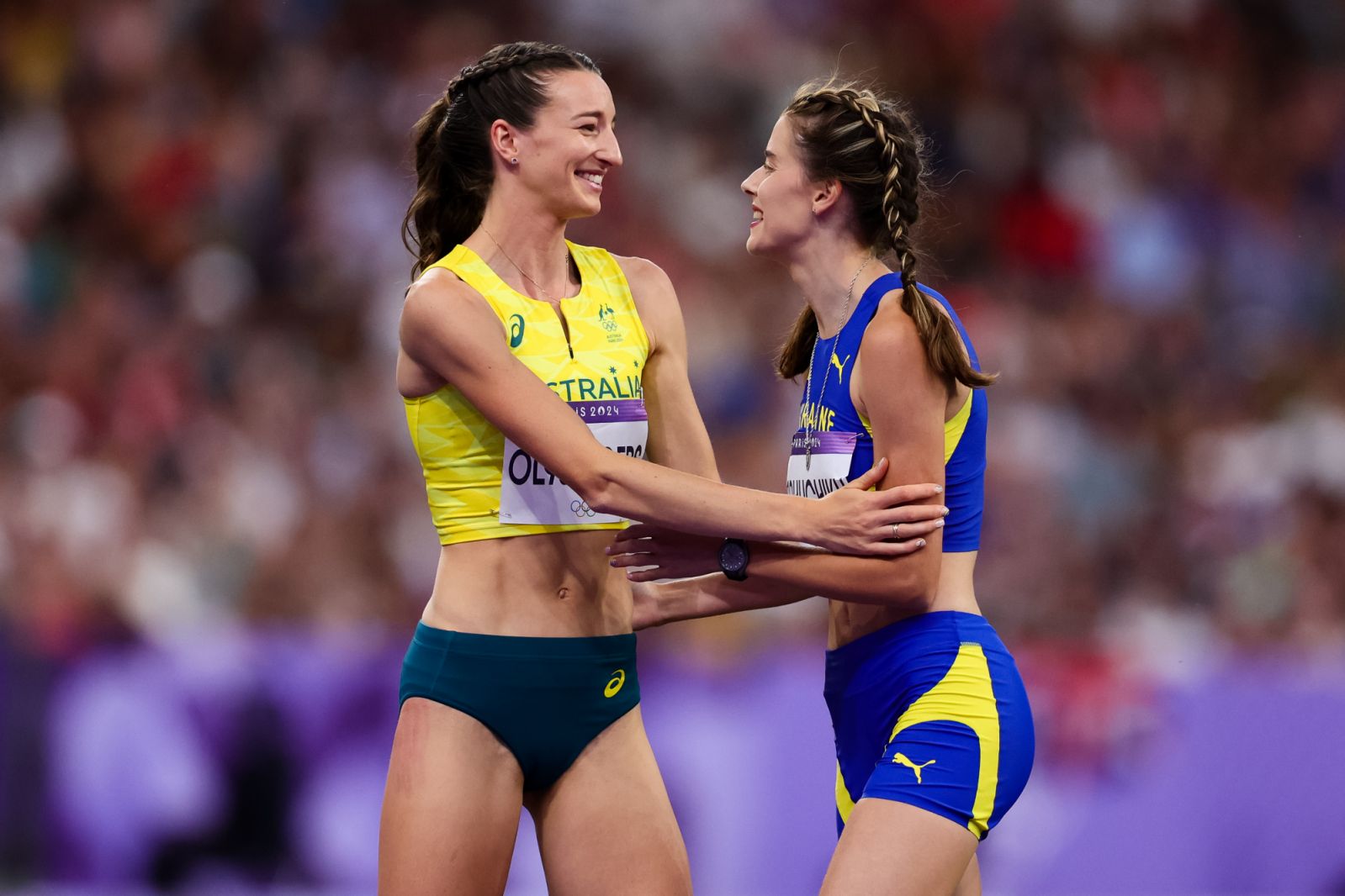 PARIS, FRANCE - AUGUST 04: Yaroslava Mahuchikh of Ukraine wins Gold, Nicola Olyslagers of Australia Silver embrace during the Women's High Jump during the Paris 2024 Olympic Games Athletics at the Stade de France on August 04, 2024 in Paris, France. (Photo by Pete Dovgan/Speed Media/Icon Sportswire via Getty Images)