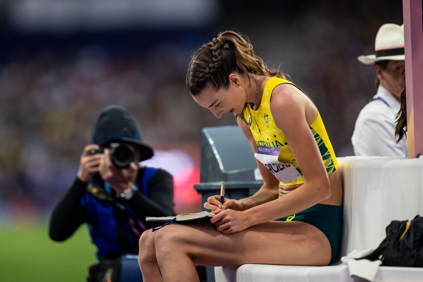PARIS, FRANCE - AUGUST 4: Nicola Olyslagers of Team Australia writes something in a book during the Women's High Jump Final on day nine of the Olympic Games Paris 2024 at Stade de France on August 4, 2024 in Paris, France. (Photo by Kevin Voigt/GettyImages)