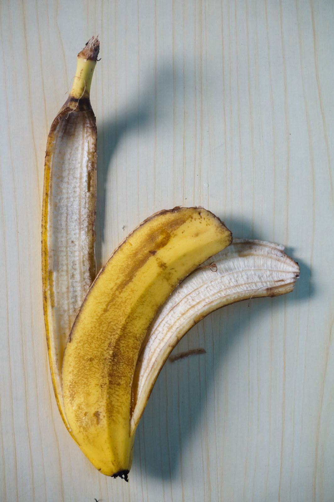 Banana peel on wooden table background. Using banana peels in compost. Zero waste concept. Top view, copy space.