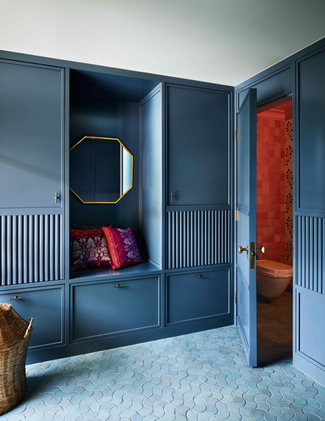 The foyer with blue-themed woodwork and flooring