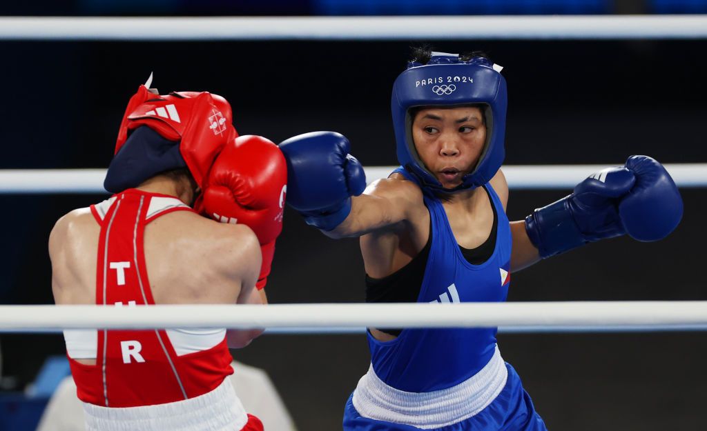 PARIS, FRANCE - AUGUST 06: Aira Villegas of Team Philippines and Buse Naz Cakiroglu of Team Turkey exchange punches during the Women's 50kg Semifinal match on day eleven of the Olympic Games Paris 2024 at Roland Garros on August 06, 2024 in Paris, France. (Photo by Richard Pelham/Getty Images)