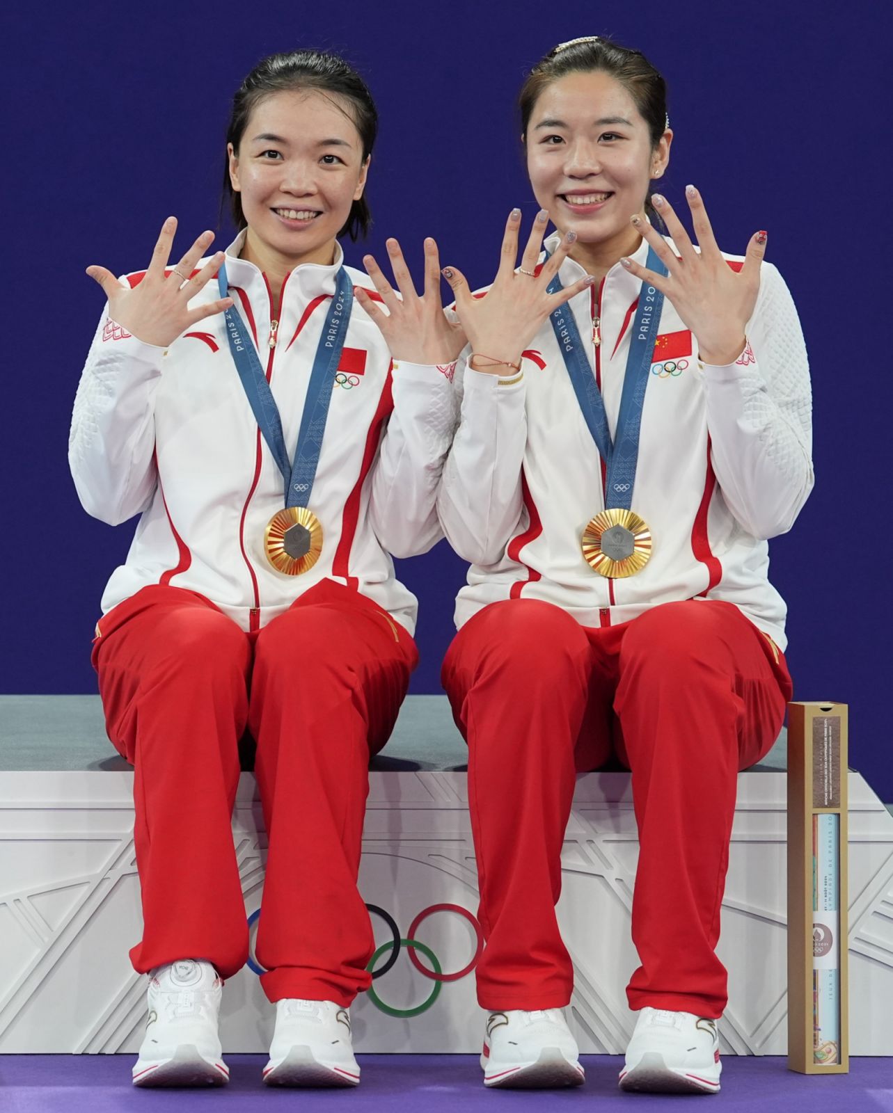 PARIS, FRANCE - AUGUST 03: Gold medalists Chen Qingchen and Jia Yifan of Team China pose with their medals on the podium during medal ceremony for the Badminton - Women's Doubles Gold Medal Match on day 8 of the Olympic Games Paris 2024 at La Chapelle Arena on August 3, 2024 in Paris, France. (Photo by Ni Minzhe/CHINASPORTS/VCG via Getty Images)