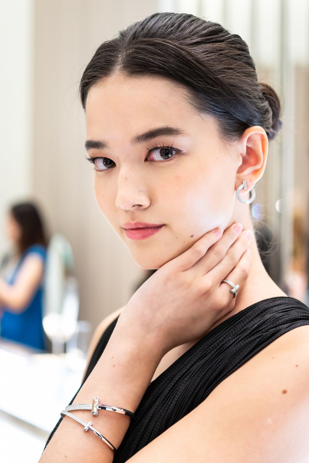 Lisa wears the Tiffany T T1 Narrow and Wide Diamond Hinged Bangle in white gold, T1 Open Hoop Earrings in white gold with diamonds, and T1 Ring in white gold with diamonds
