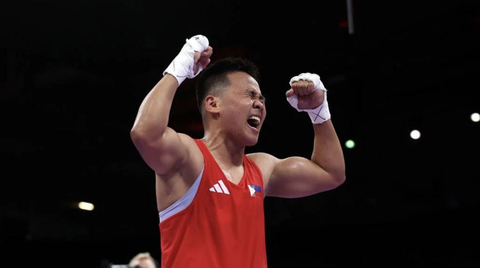 Nesthy Petecio of Team Philippines celebrates victory against Zichun Xu of Team People’s Republic of China (Photo: Richard Pelham / Getty Images)