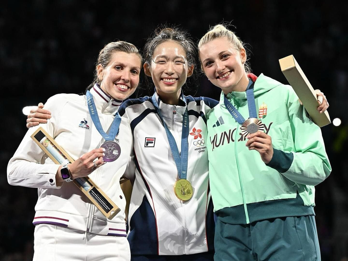 Sliver medalist Auriane Mallo (R) from France, gold medalist Vivian Kong (C) from Hong Kong, bronze medalist Eszter Muhari (L) from Hungary takes a group photo on the podium at the award ceremony for the women’s épée individual event at this year’s Games (Photo: Getty Images)