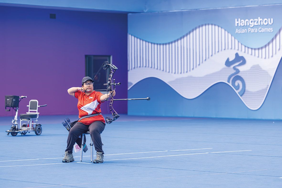 The national para‑archer shoots while sitting on a stool