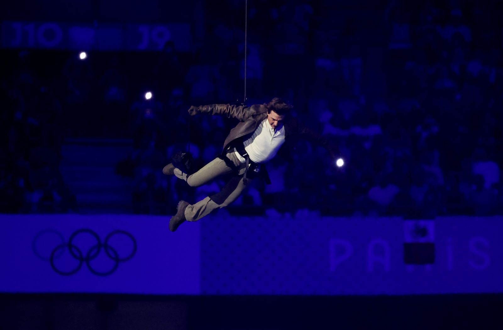 PARIS, FRANCE - AUGUST 11: Actor Tom Cruise jumps from the roof of the Stade de France during the Closing Ceremony of the Olympic Games Paris 2024  at Stade de France on August 11, 2024 in Paris, France. (Photo by Fabrizio Bensch- Pool/Getty Images)