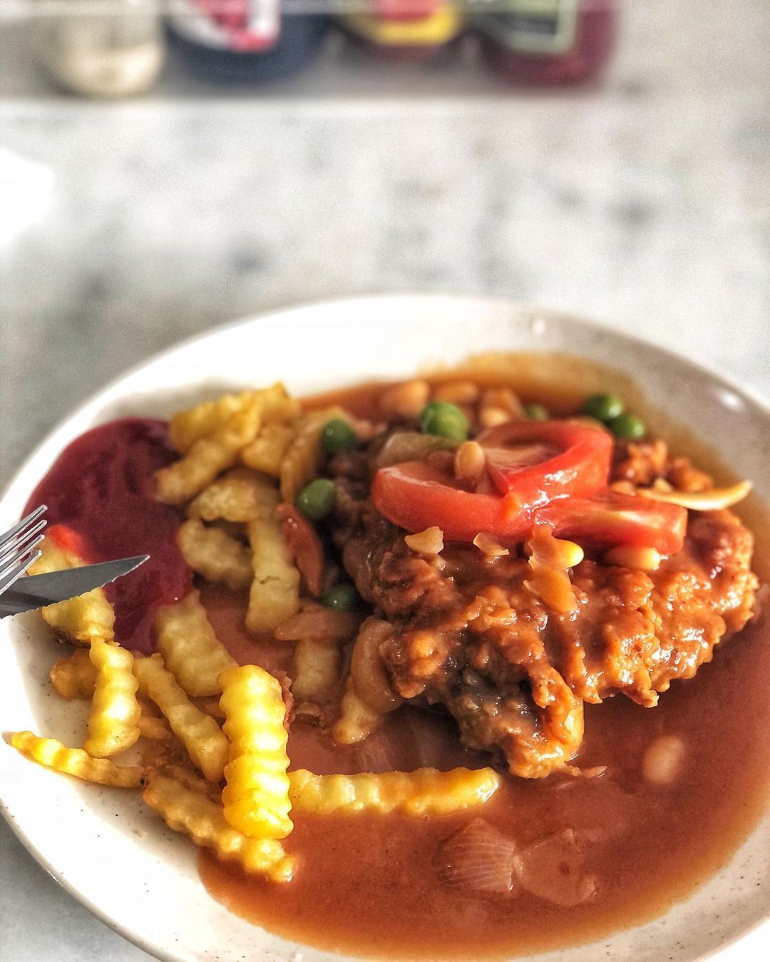 A Hainanese chicken chop served with fries (Photo: Instagram / @foodieonabittenapple)