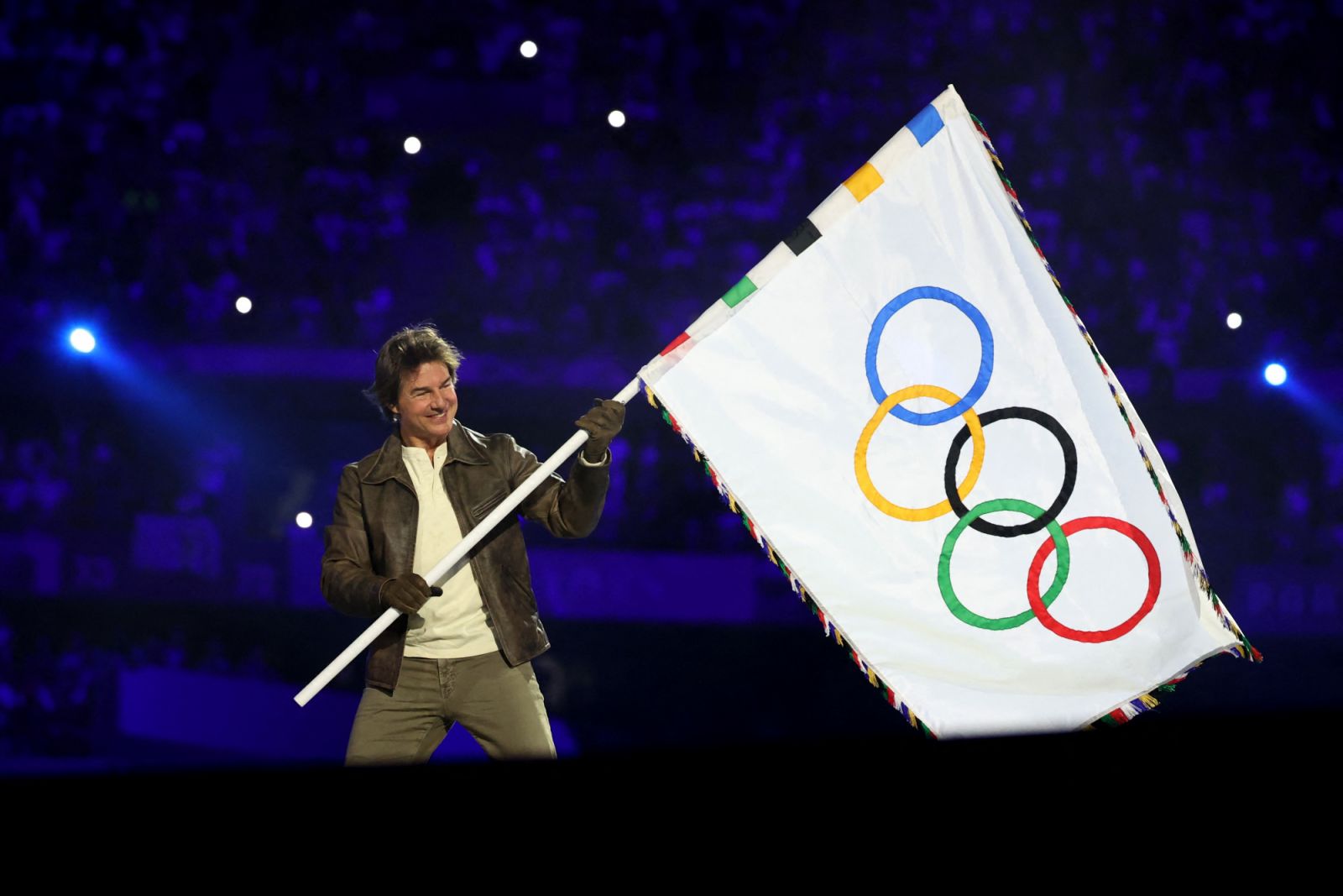 PARIS, FRANCE - AUGUST 11: Actor Tom Cruise holds the Olympic flag during the Closing Ceremony of the Olympic Games Paris 2024 at Stade de France on August 11, 2024 in Paris, France. (Photo by Fabrizio Bensch- Pool/Getty Images)