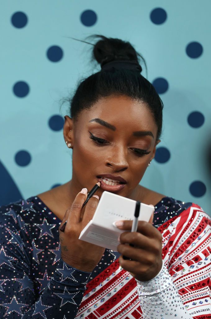 PARIS, FRANCE - JULY 30: Simone Biles of Team United States applies makeup before competing in the floor exercise during the Artistic Gymnastics Women's Team Final on day four of the Olympic Games Paris 2024 at Bercy Arena on July 30, 2024 in Paris, France. (Photo by Naomi Baker/Getty Images)