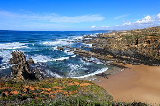 Praia da Barca Grande beach with beautiful rocks and cliffs in the coast of Alentejo, Portugal (Photo: Getty Images)