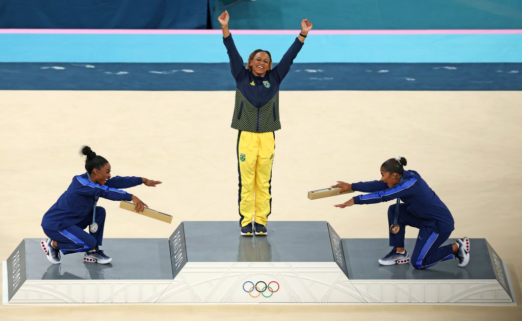 Simone Biles and Jordan Chiles of team US bow to gold medallist Rebeca Andrade of team Brazil at the podium at the artistic gymnastics women’s floor exercise medal ceremony at the Olympics—a moment that will go down as one of the most iconic moments of female solidarity in elite sports (Photo: Getty Images)