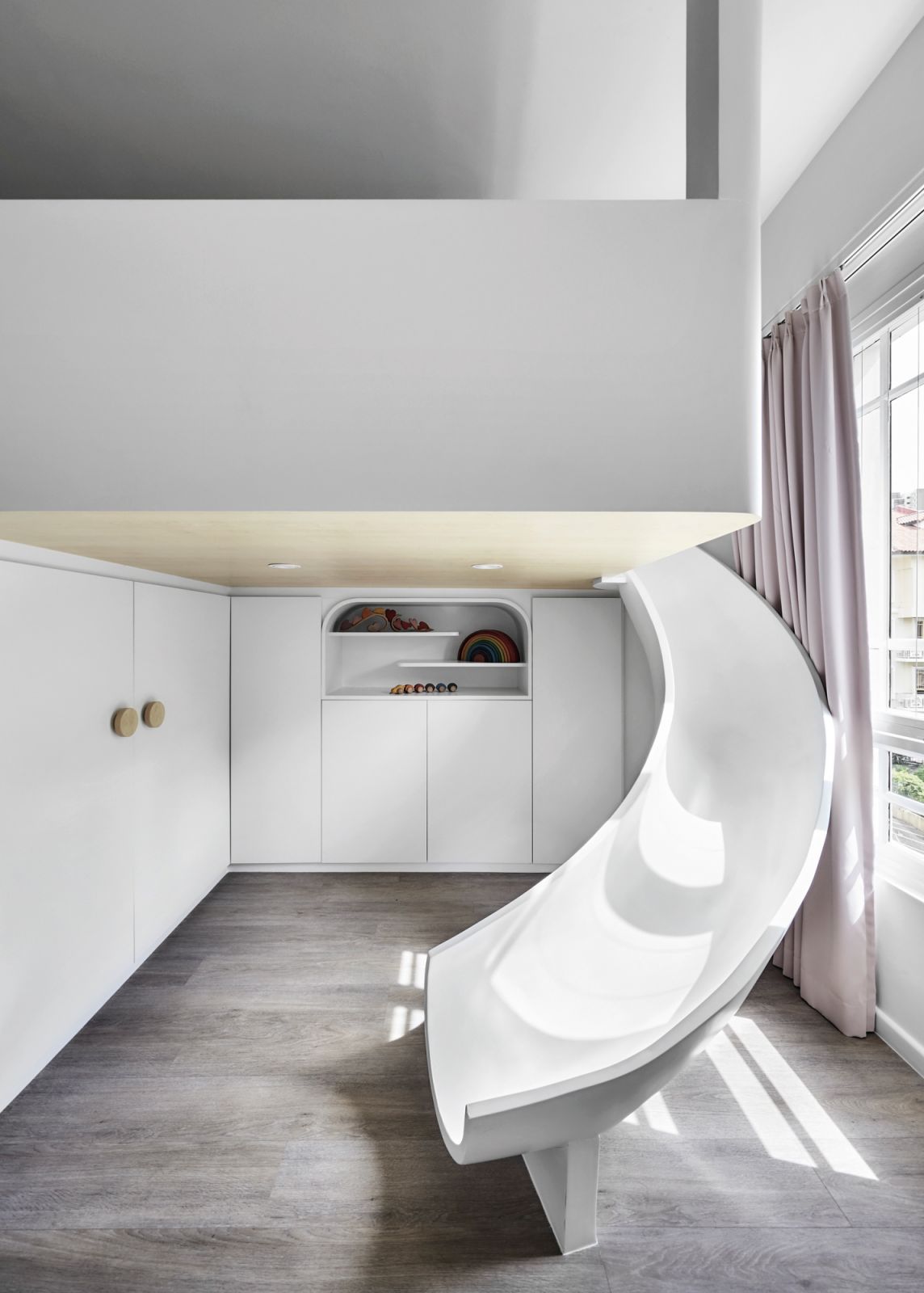 This children’s room features a playful slide