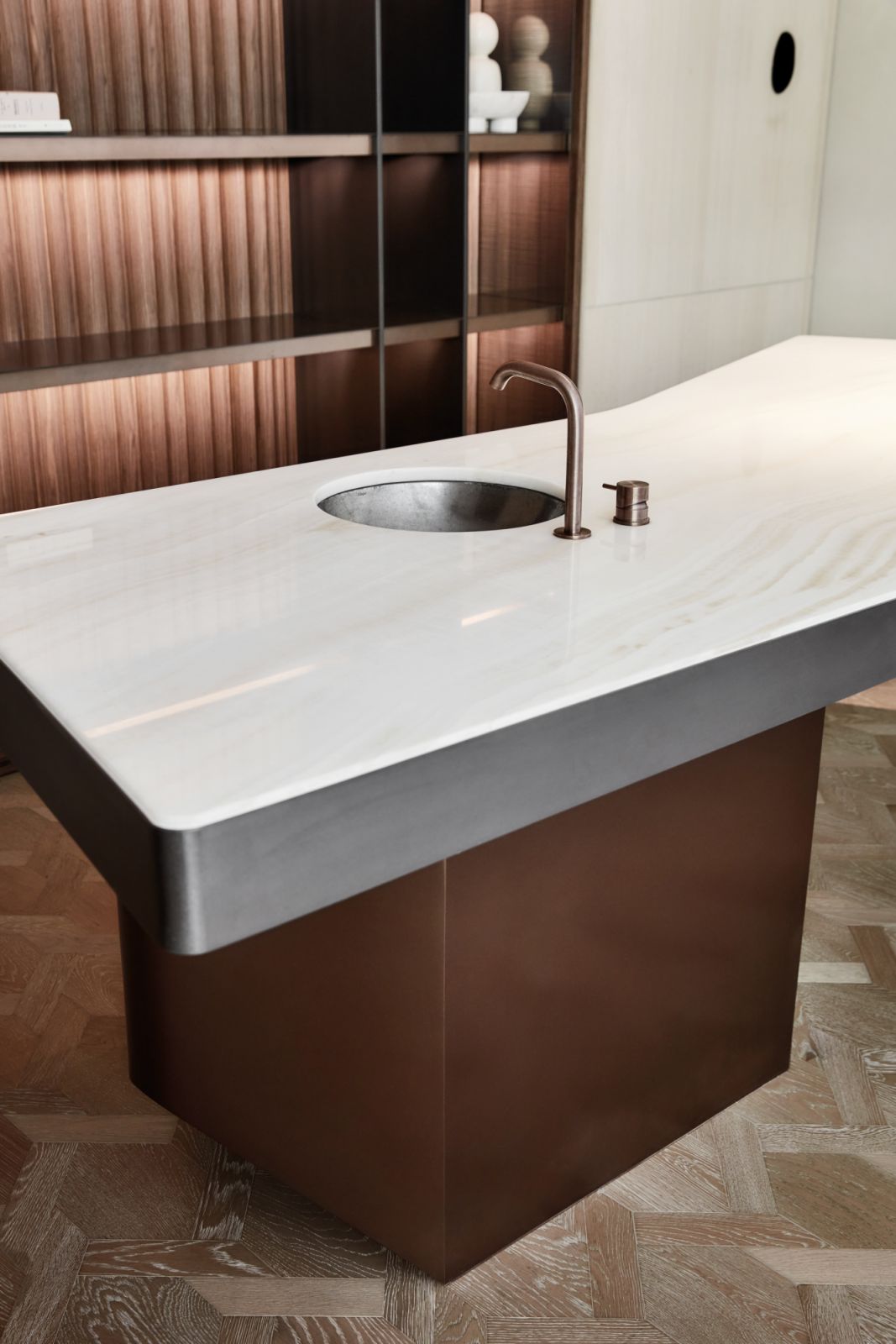 The apartment’s sculptural kitchen island