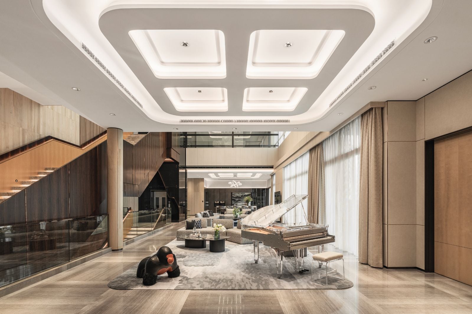 A clear-finish piano and gorilla stool add a dose of quirky personality to the grand living area