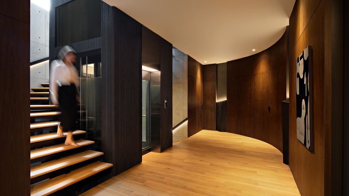 charred shou sugi ban timber lends a stylish look to the elevator core