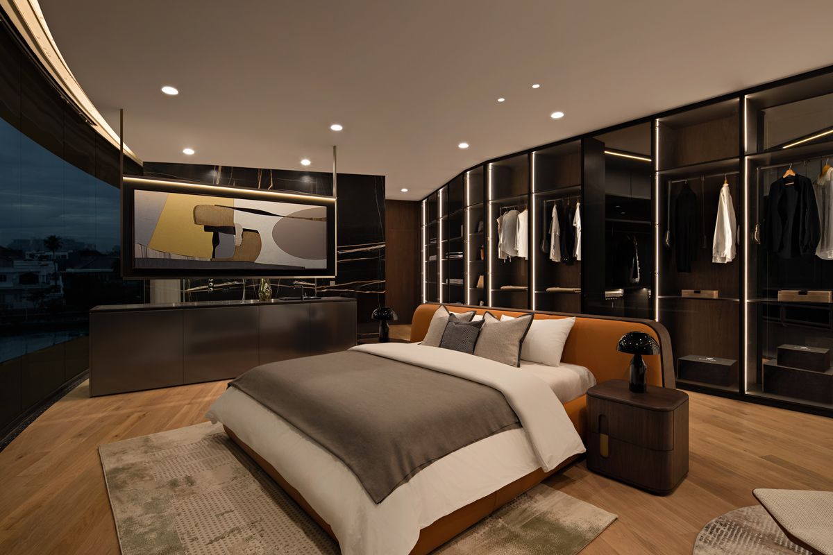 The master bedroom features a large wardrobe and a striking feature wall that hides the ensuite bathroom