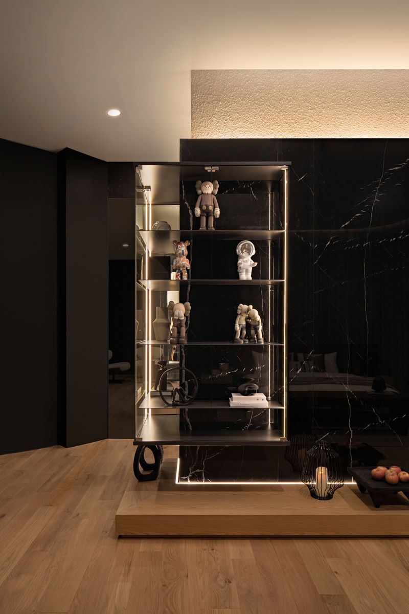 These display shelves for figurines make a delightful contrast to the masculine palette