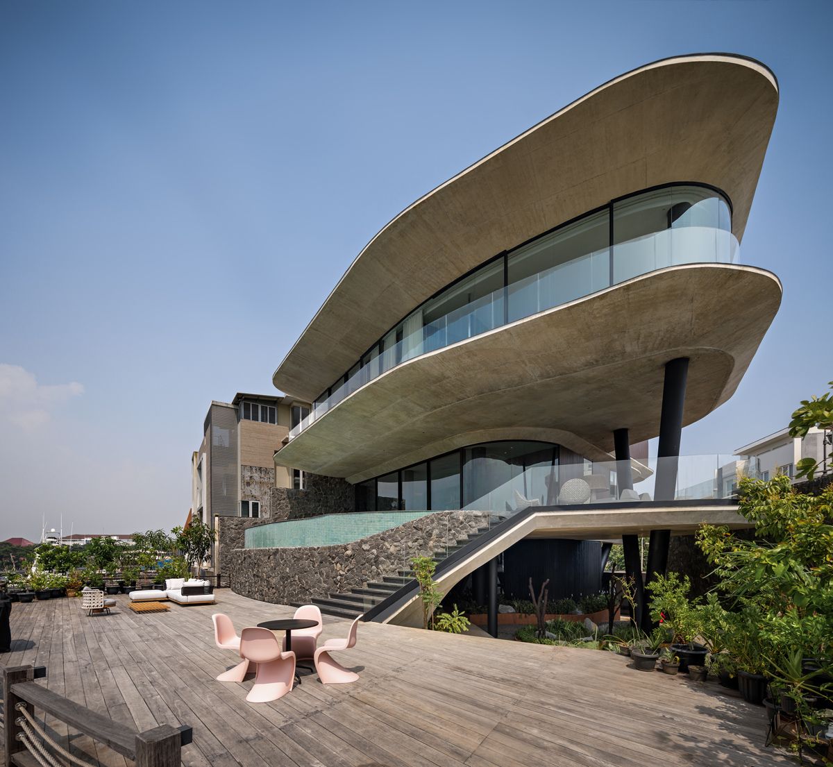 The house viewed from its private jetty showcases its organic floor plates