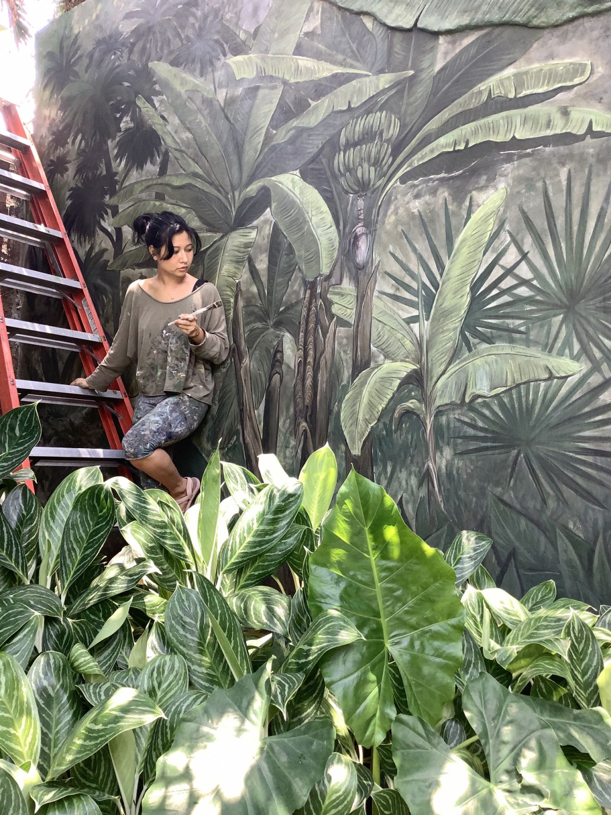 Tara Soriano with her mural at a private house in Forbes