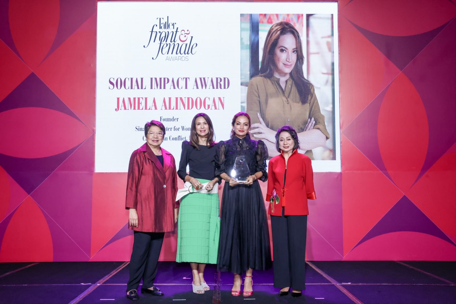 Jamela Alindogan receiving the Social Impact Award, presented by Chit Juan Trickie Lopa and Chit Lijauco