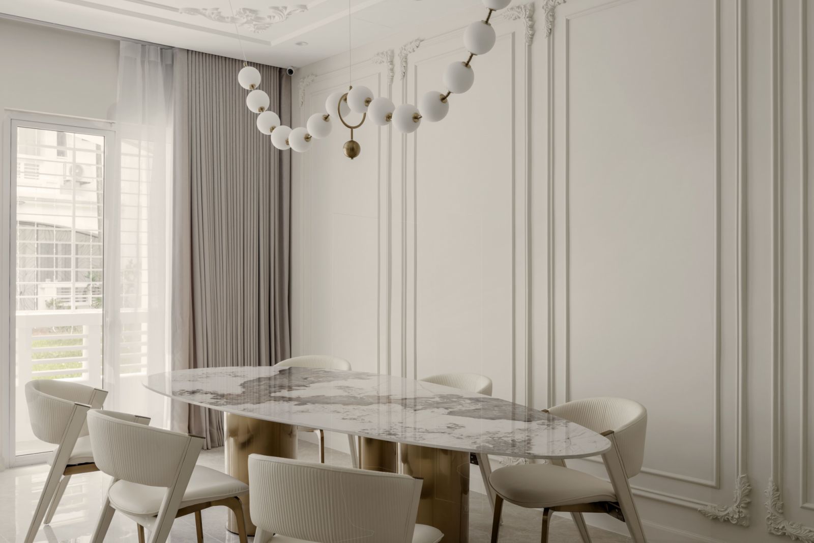 The dining area has a decorative lighting fixture resembling a strand of pearls