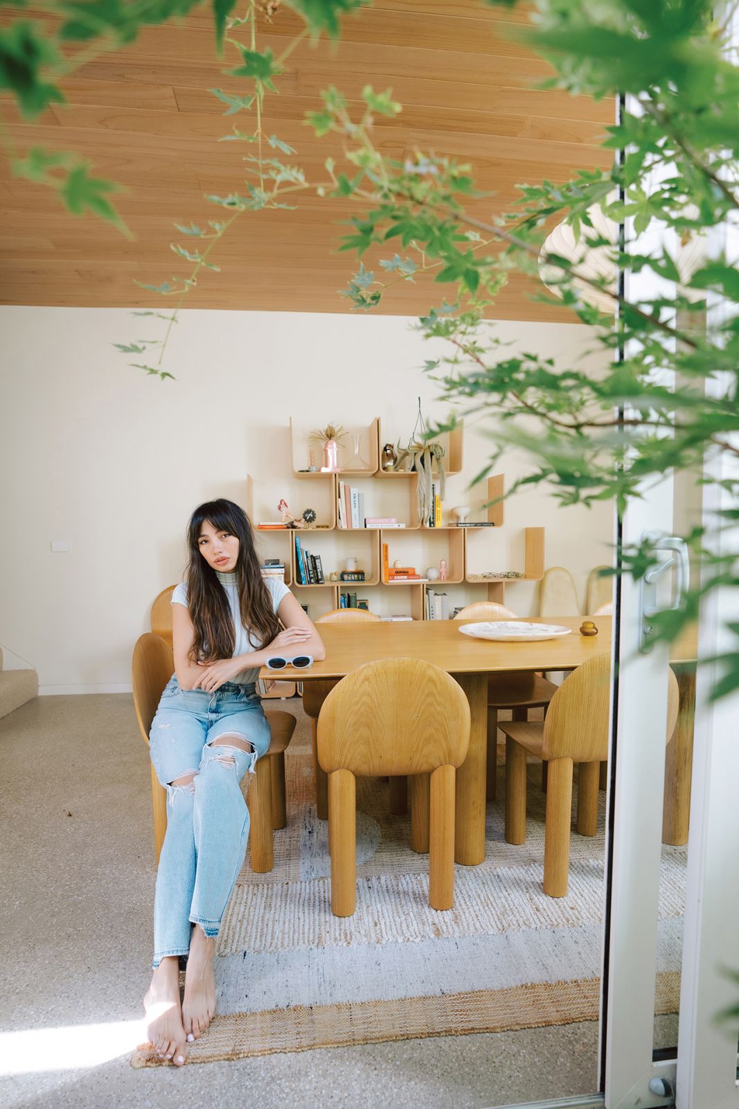 Martine Ho lounging in her Melbourne home’s dining room