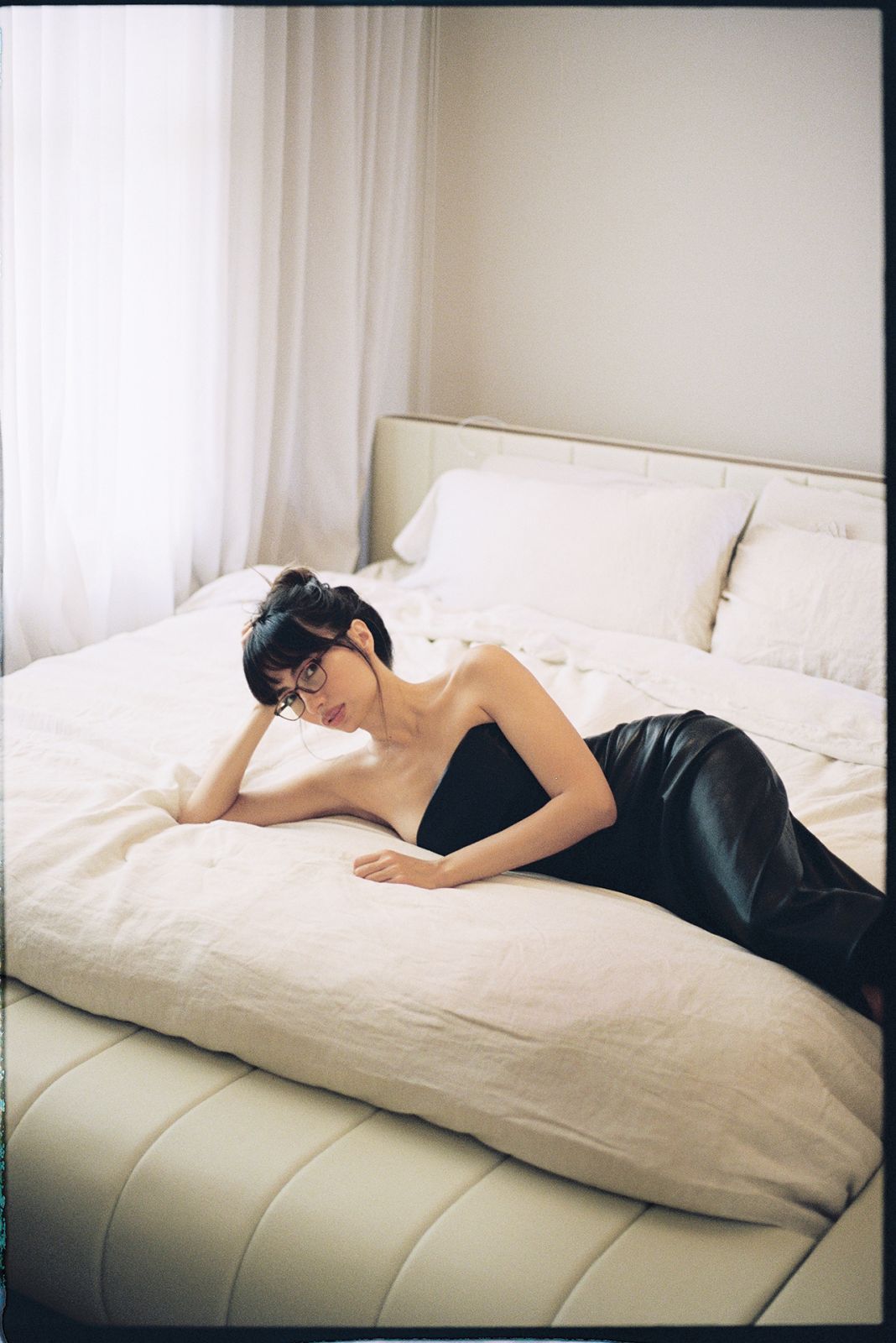 Martine lounging in her bedroom