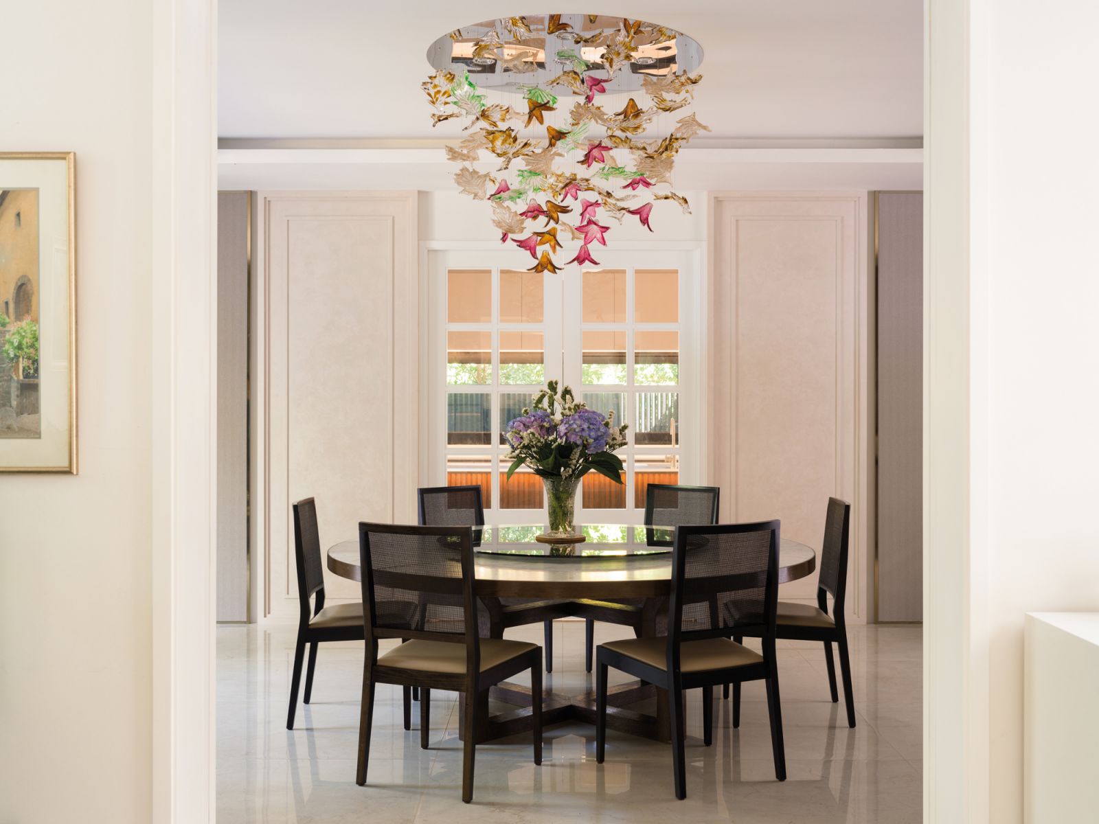 A floral glass chandelier creates a romantic air