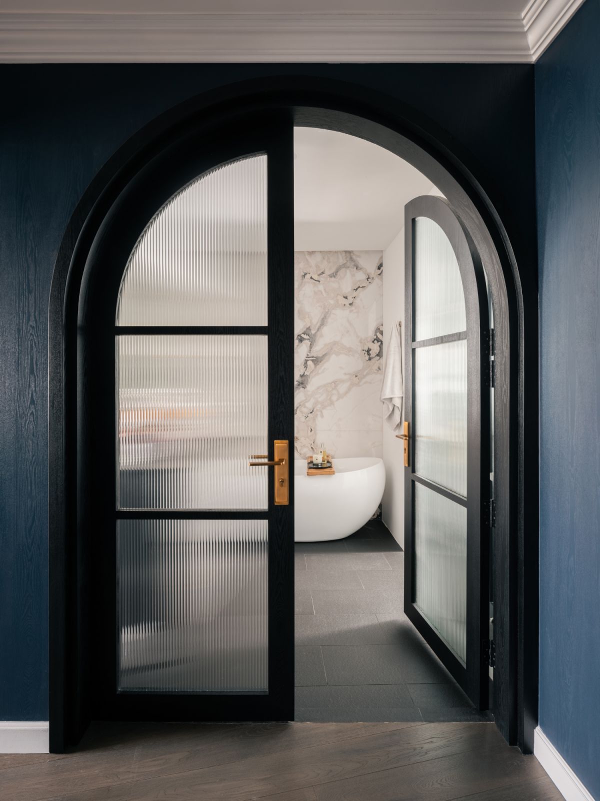 A grand, curved entrance leads into the Cairnhill Plaza bathroom