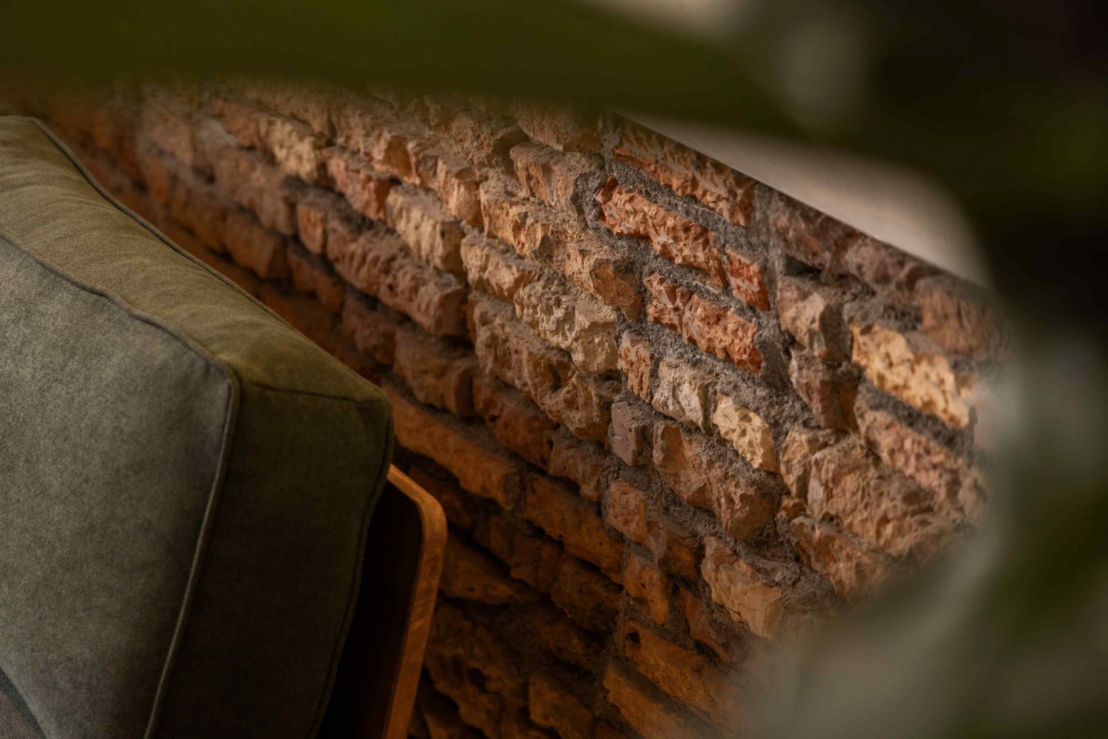 The exposed brick walls from the original structure serve both aesthetic and sustainable purposes