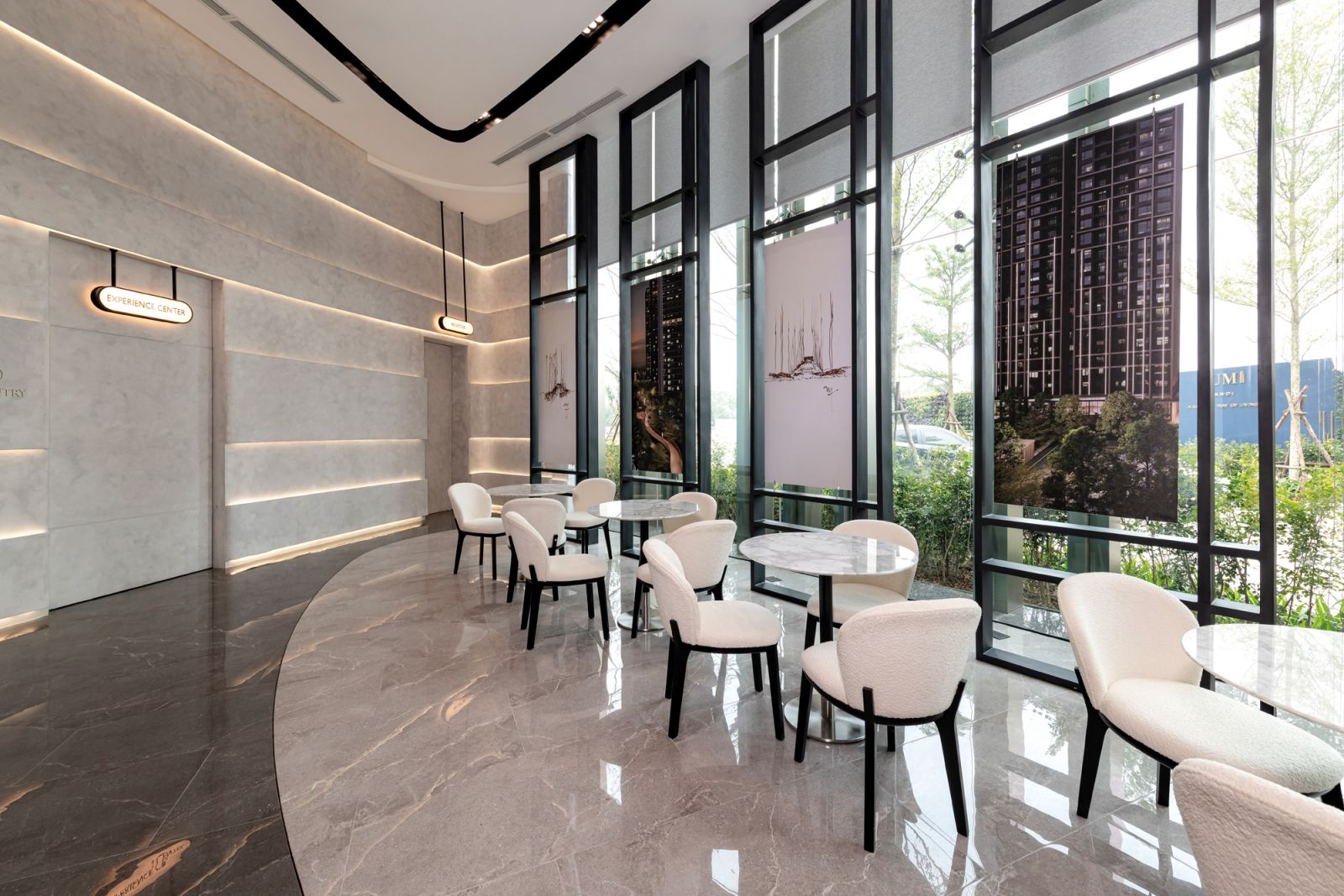 Polished white marble tables and soft ambient lighting create a welcoming atmosphere