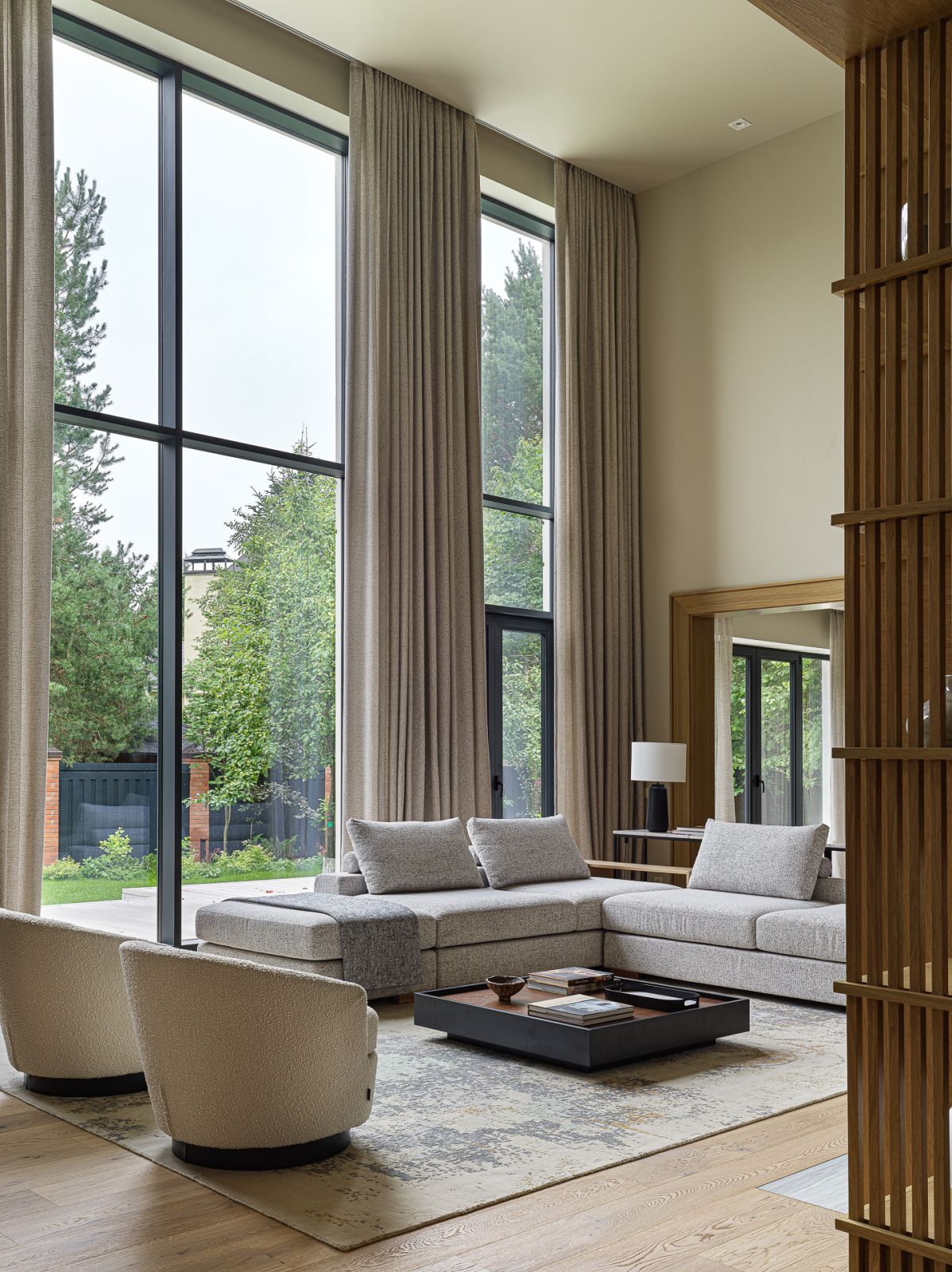 Floor-to-ceiling windows overlook the inner courtyard and garden