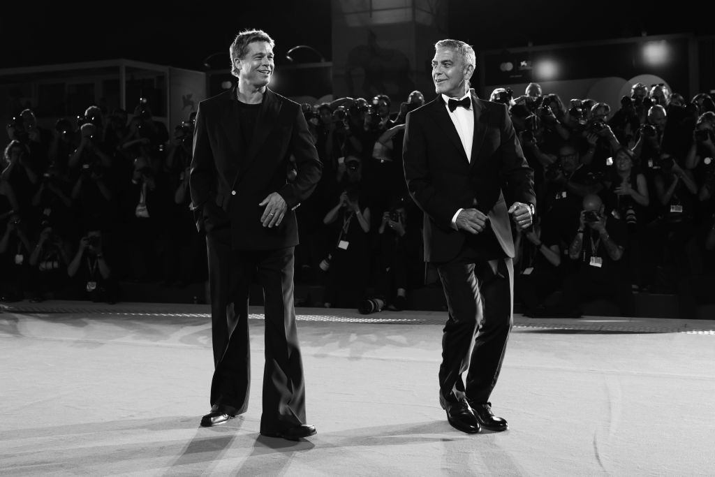 VENICE, ITALY - SEPTEMBER 01: Brad Pitt and George Clooney attend the "Wolfs" red carpet during the 81st Venice International Film Festival on September 01, 2024 in Venice, Italy. (Photo by Vittorio Zunino Celotto/Getty Images)